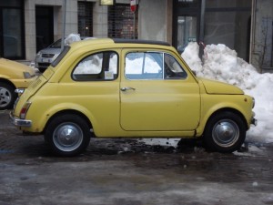 Yellow old Fiat 500 in the snow
