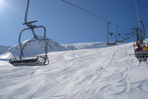 Chairlift over sunny slopes in Roccaraso
